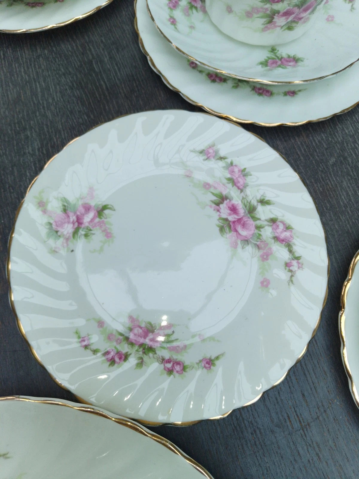 Antique pink rose tea set plate with delicate floral design and gold trim on white porcelain