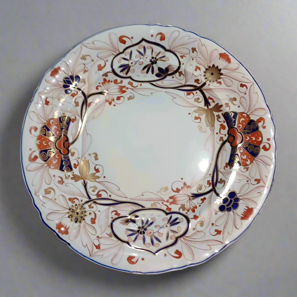 Copeland Spode Imari dinner plate with intricate floral and geometric patterns in blue, red, and gold