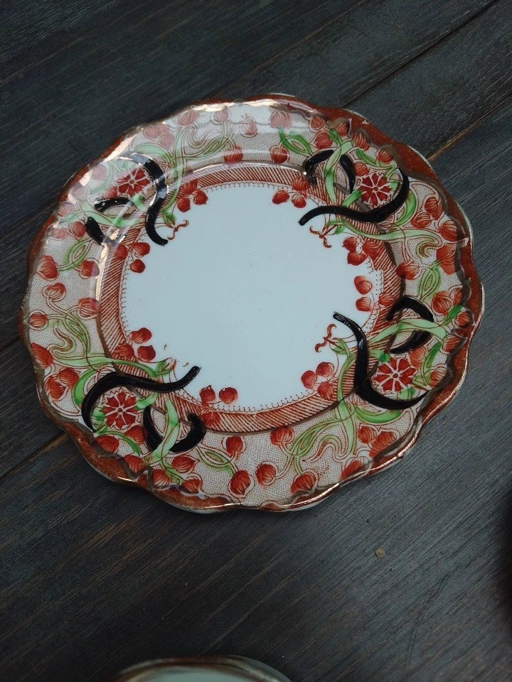 Decorative plate from an antique Imari tea trio with intricate red and green floral patterns