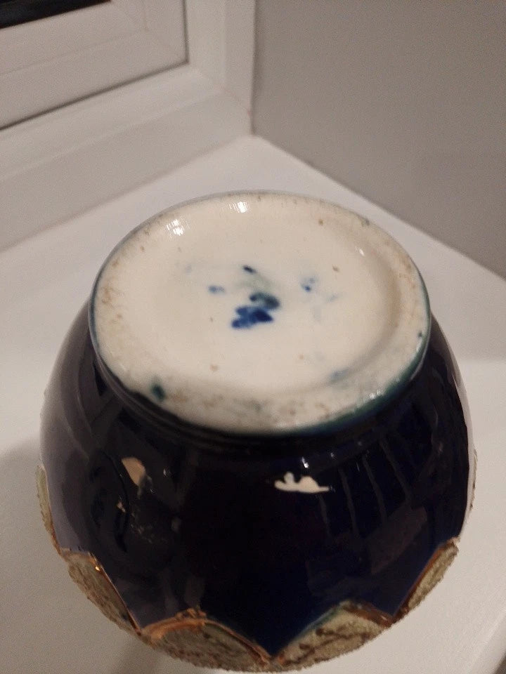 Base of a Thomas Forester majolica vase antique showing dark blue glaze and worn edges