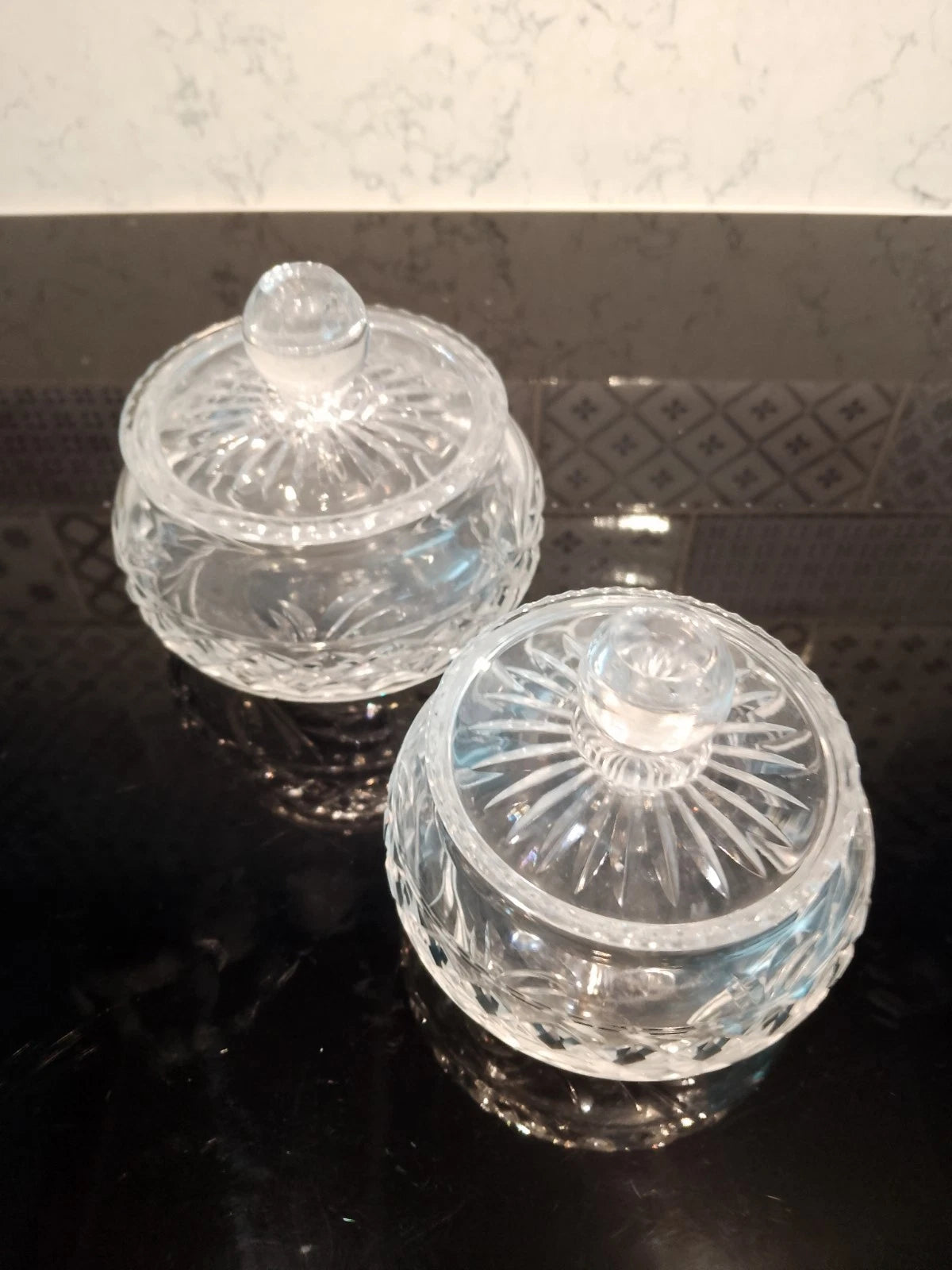 Pair of vintage Stuart crystal jars with intricate cut glass patterns and lids