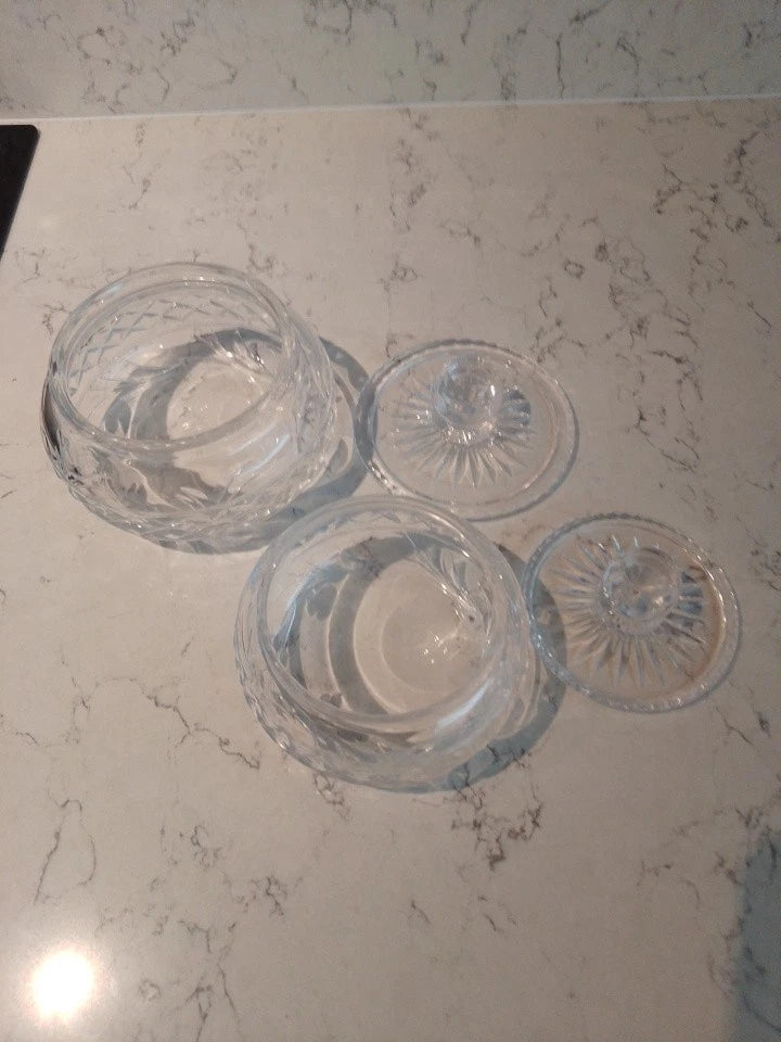 Pair of vintage Stuart crystal jars with intricate cut glass design and matching lids on marble surface