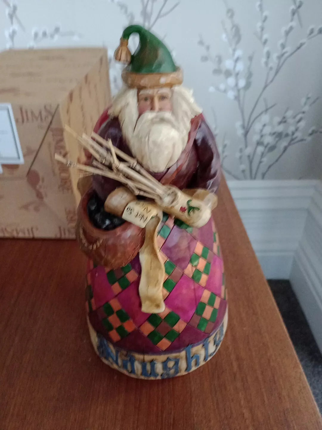 Hand-painted Santa figurine holding wooden sticks from vintage and new Christmas collectables collection