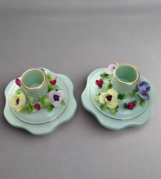 Pair of Adderley bone china candleholders with floral design and gold trim on pale green base
