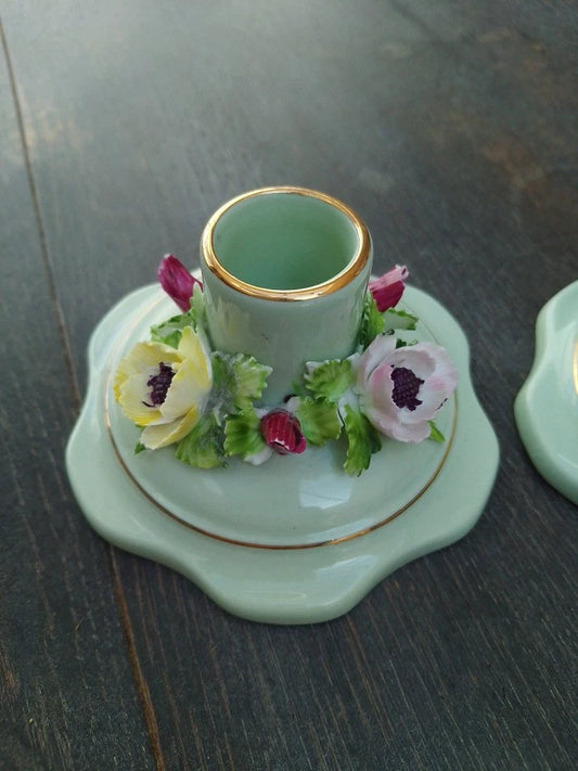 Adderley bone china candleholders with delicate floral decorations and gold trim on pastel green base