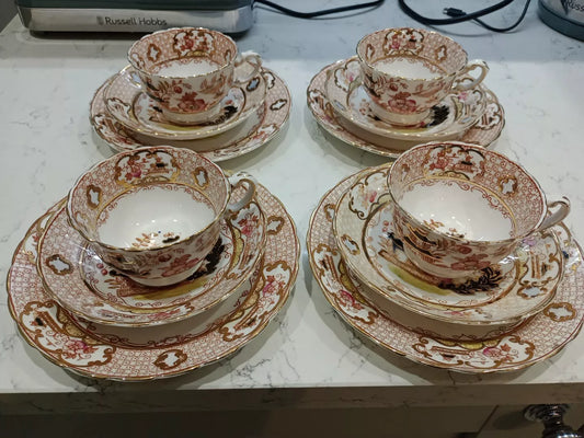 Set of four antique Charles Amison tea trios with floral and gold decorative patterns on white china