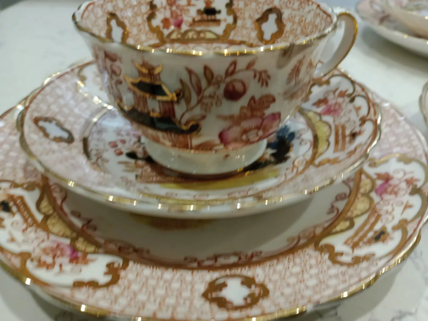 Antique Charles Amison tea trios with ornate floral and pagoda design in fine china and gold accents