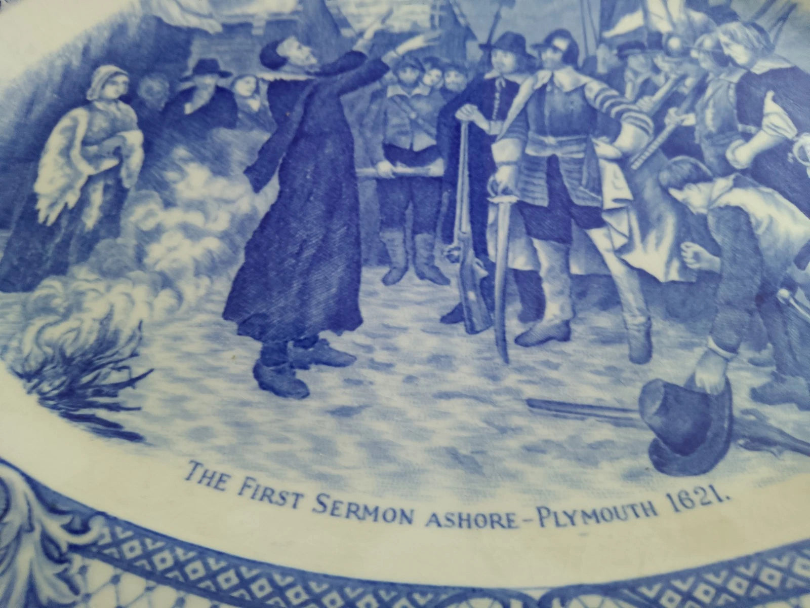 Close-up of The First Sermon Ashore crown ducal plate showing a historical Plymouth 1621 scene with pilgrims and native figures