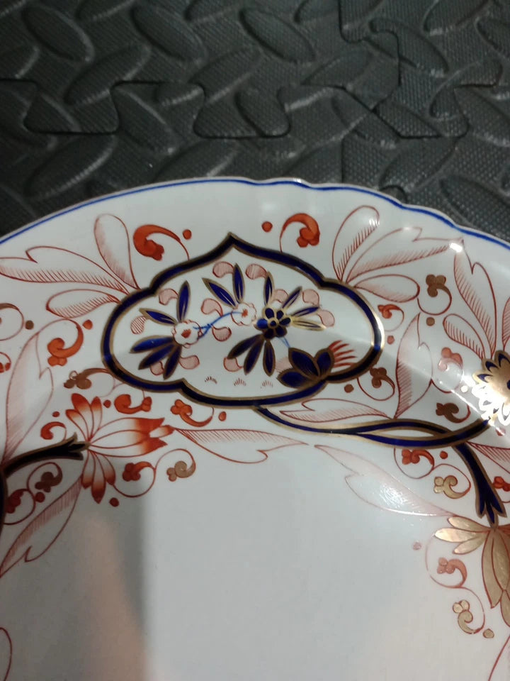 Copeland Spode Imari dinner plate with intricate blue and red floral patterns on white porcelain