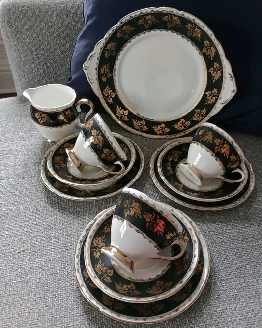 Gladstone China tea set vintage with black and gold floral pattern including cups saucers plates and a creamer jug