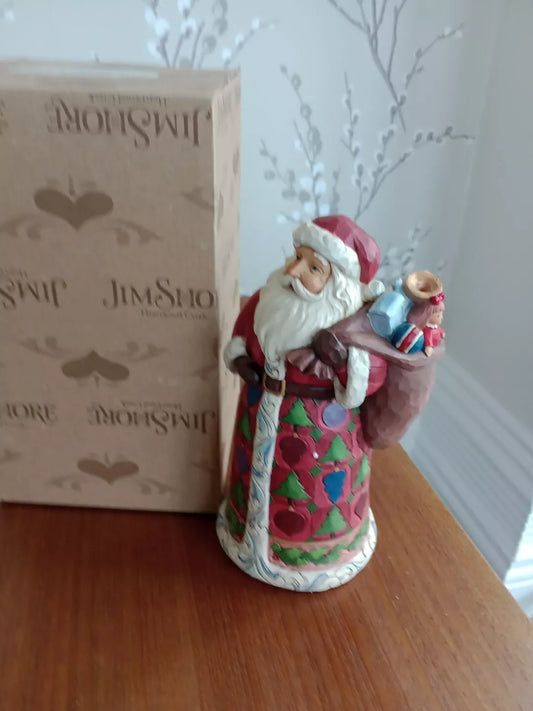 Jim Shore Heartwood Creek Santa figurine in traditional red outfit holding a sack of gifts with decorative patterns
