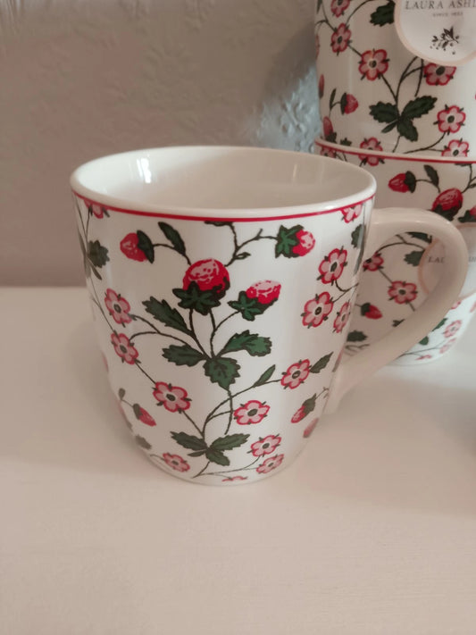 Laura Ashley strawberry mugs set featuring white ceramic mugs decorated with red strawberries and floral patterns