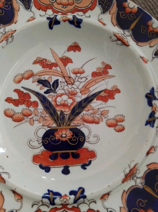 Masons Ironstone Imari soup plate with intricate floral design in blue and orange on white porcelain