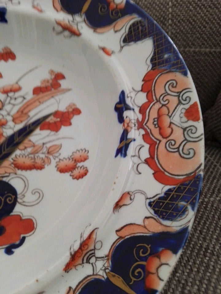 Close-up of Masons Ironstone Imari soup plate showing detailed floral and geometric patterns in blue, red, and gold