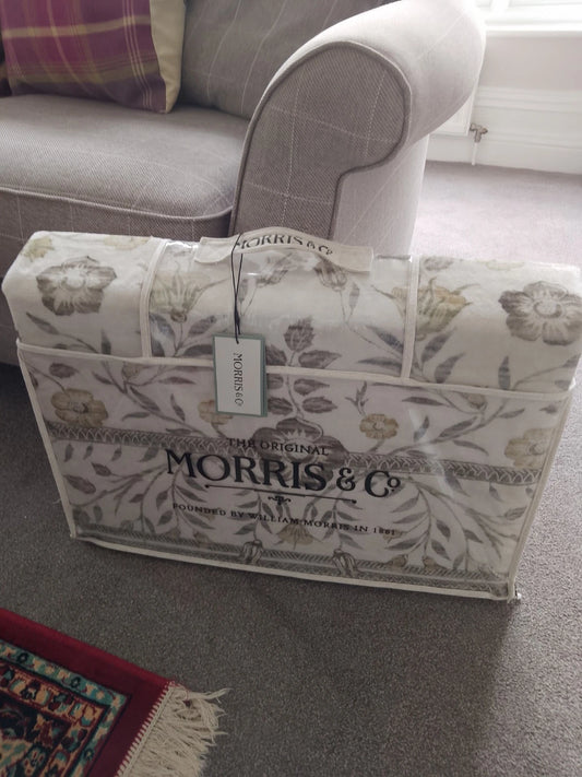 William Morris rug 5ft x 7ft packaged in Morris & Co floral fabric bag near grey sofa