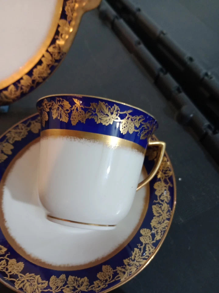 Adderleys cobalt blue tea set featuring a white cup and saucer with intricate gold floral designs