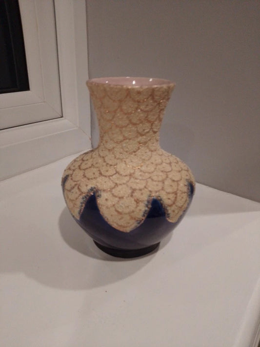 Thomas Forester coralene vase with textured cream upper and deep blue base on white surface
