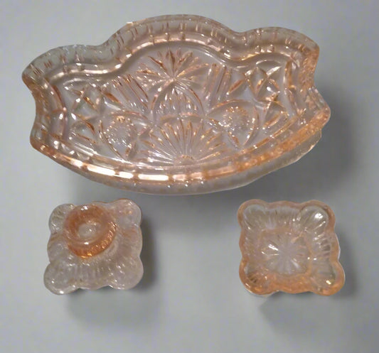 Vintage pressed glass vanity set with ornate pink glass dishes and detailed patterns
