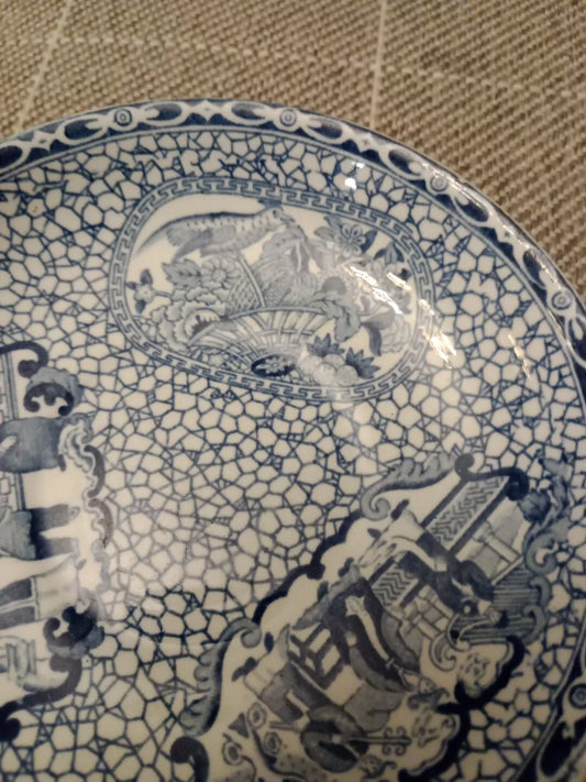 William Adams blue and white saucer with intricate floral and architectural patterns on crackle glaze